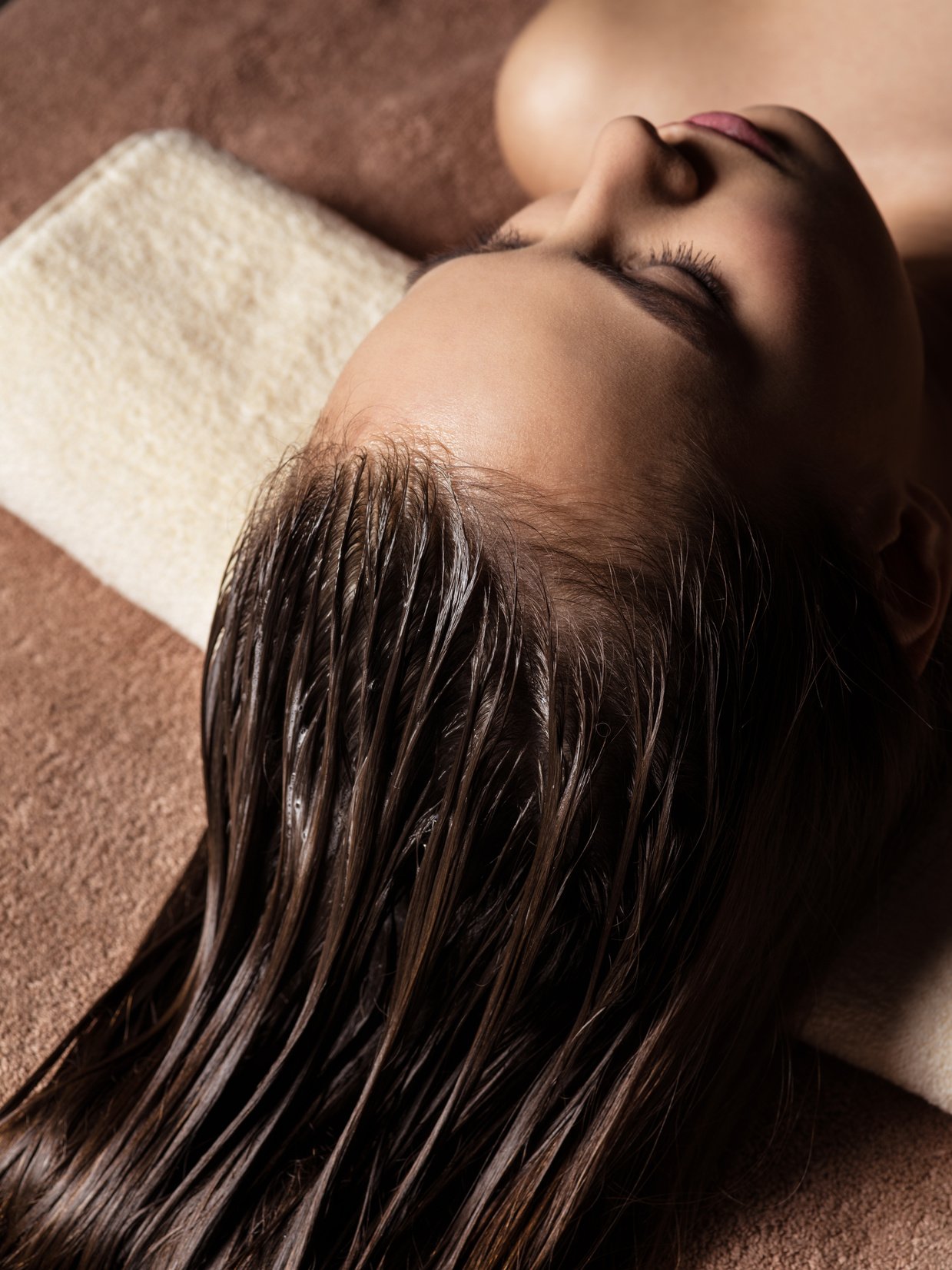 Woman Receiving Hair Care Procedure  in Spa Salon